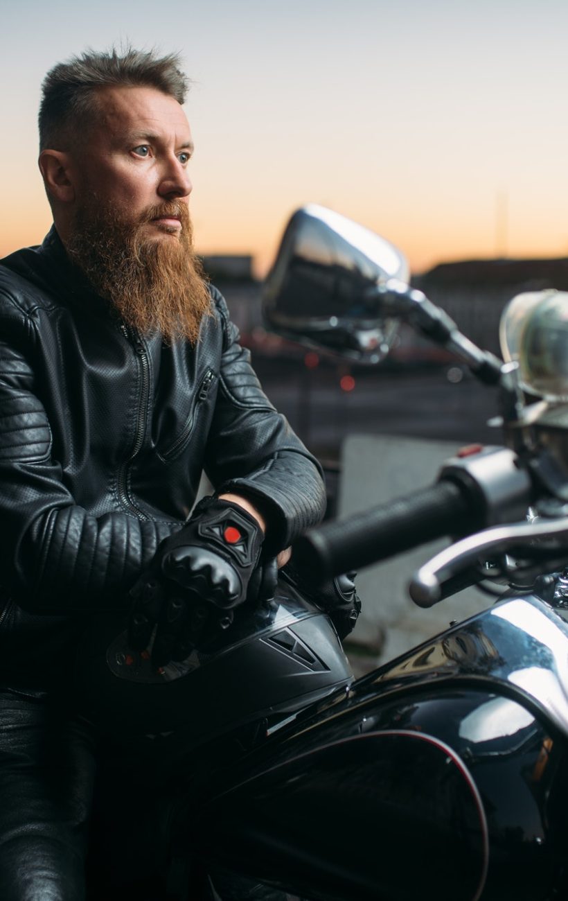 biker-poses-on-a-motorcycle-in-city-on-sunset.jpg